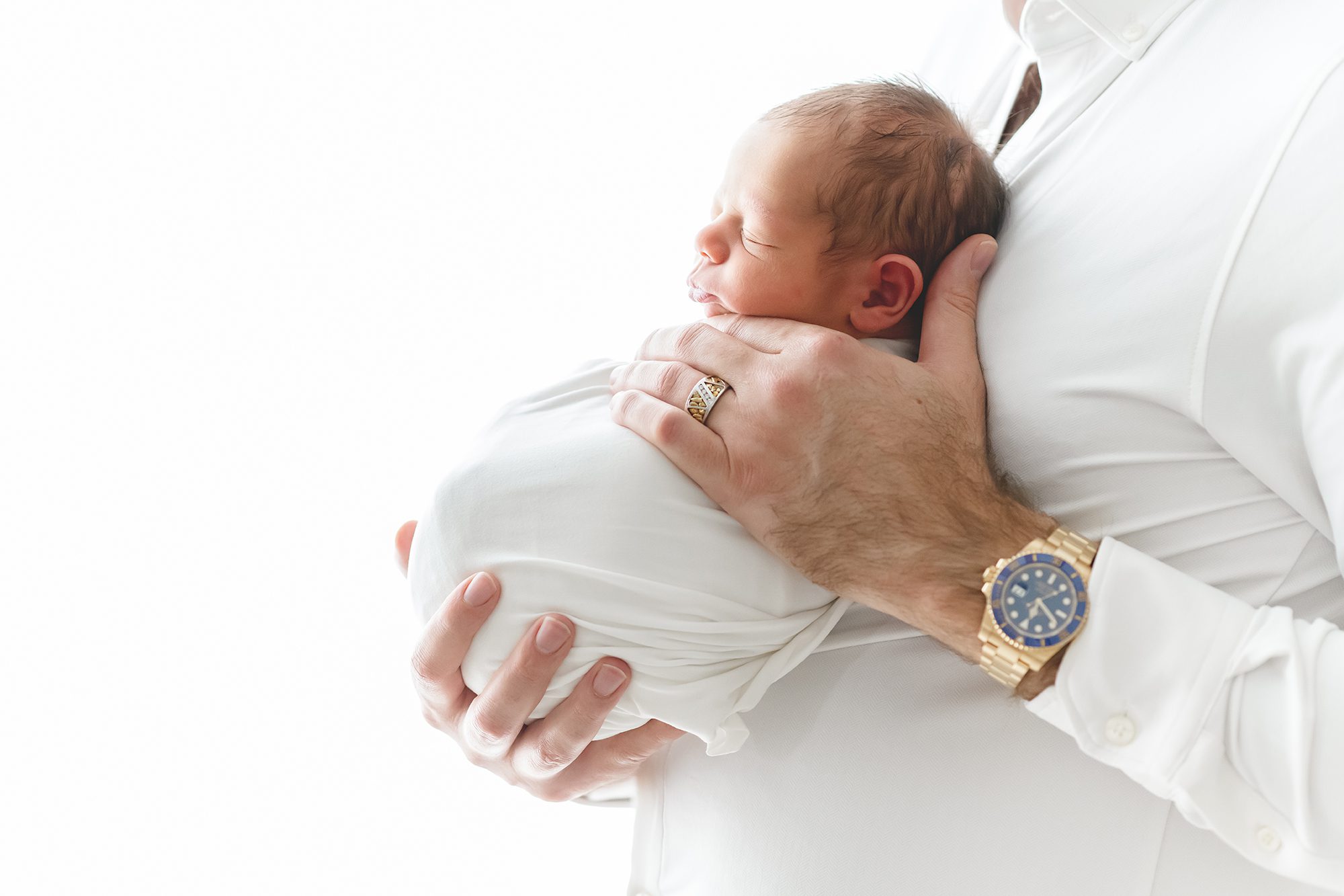Reaj Roberts Photography | Scottsdale newborn photographer newborn baby held in father's hands light and airy