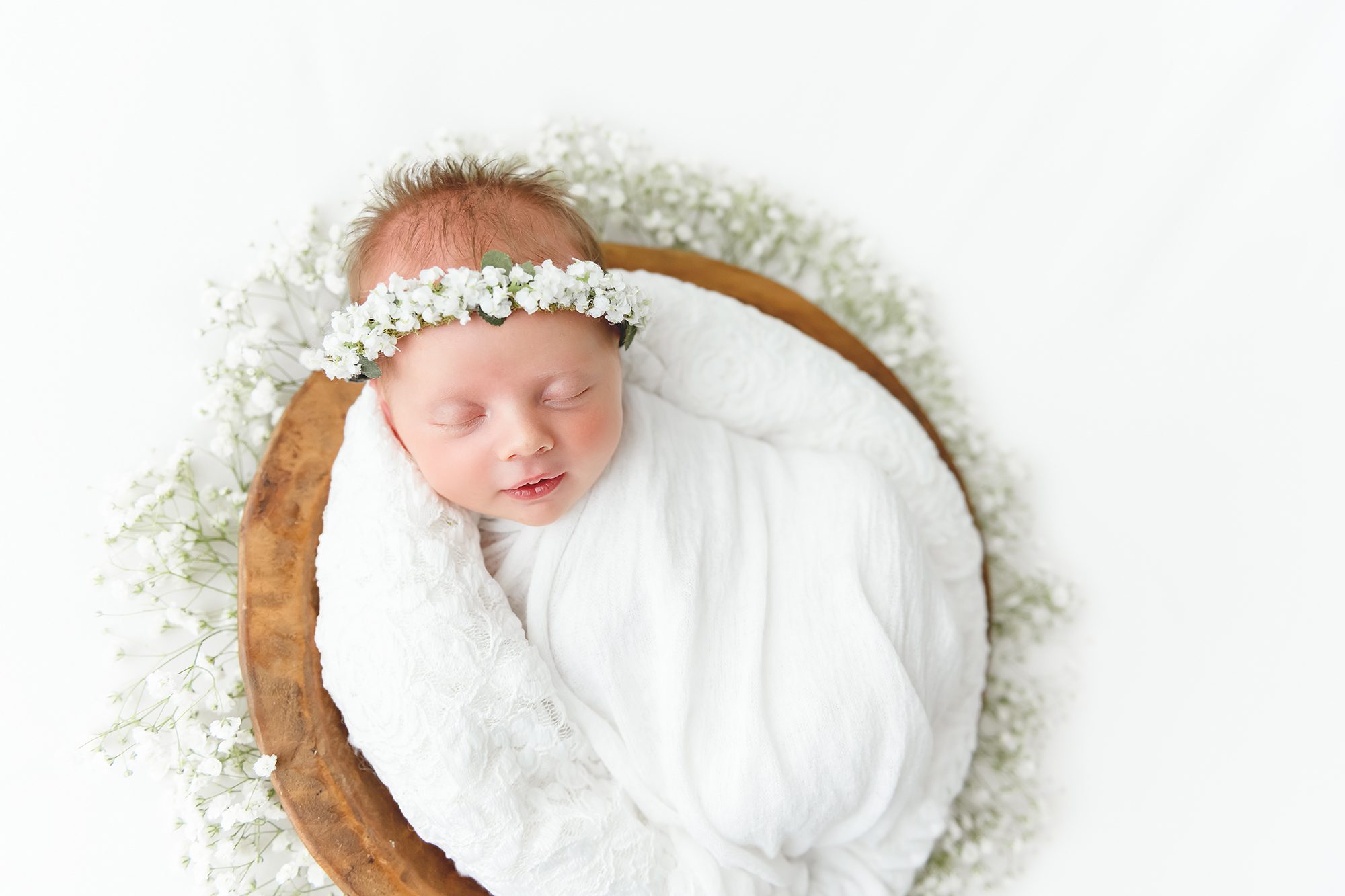 Reaj Roberts Photography newborn in wood bowl with baby's breath
