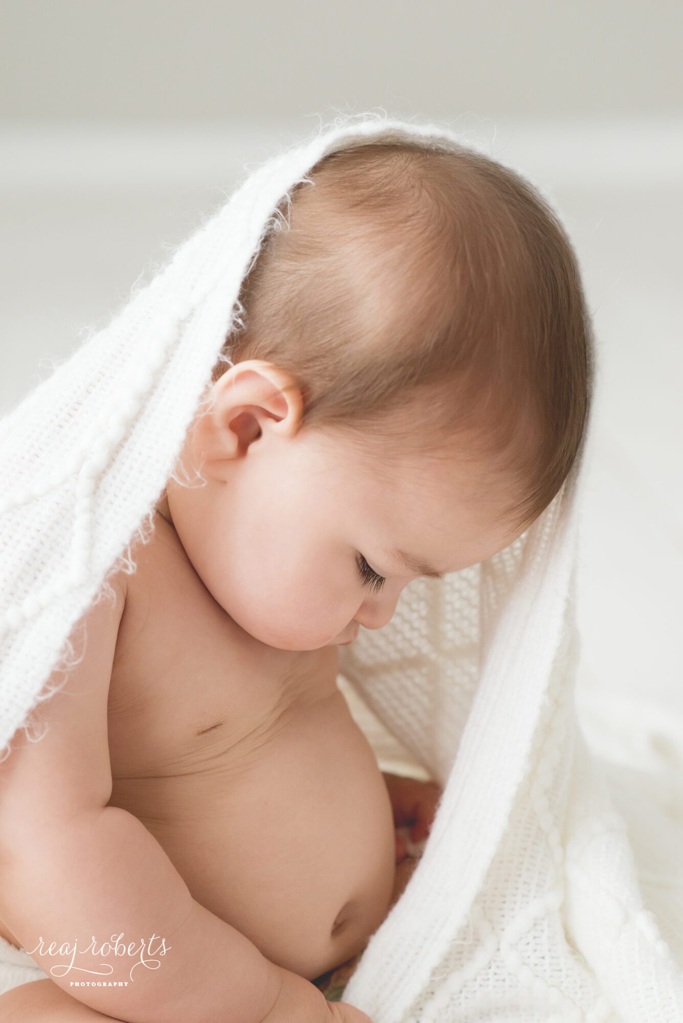 Baby with simple white blanket