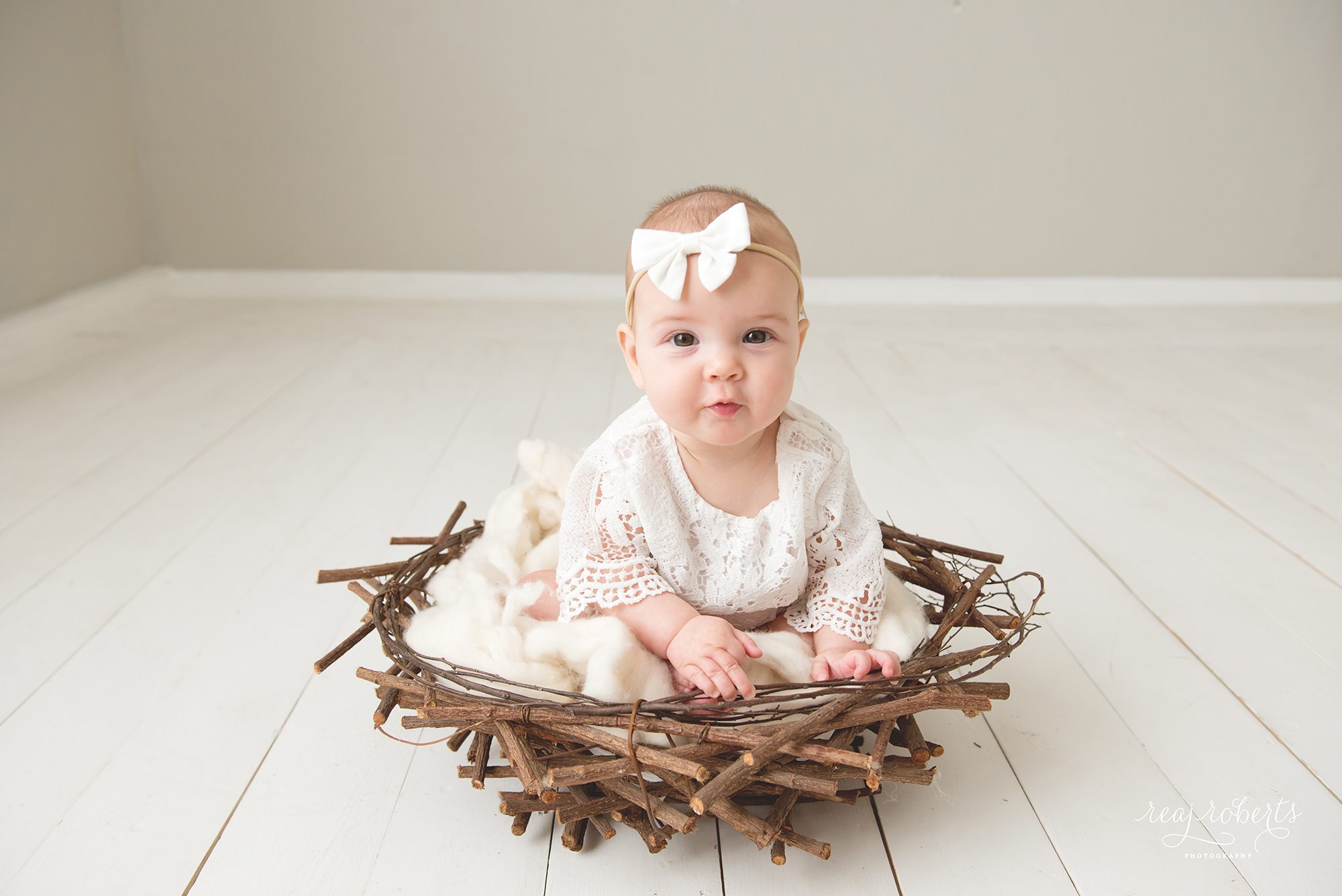 Baby girl in nest photographer | Reaj Roberts Photography