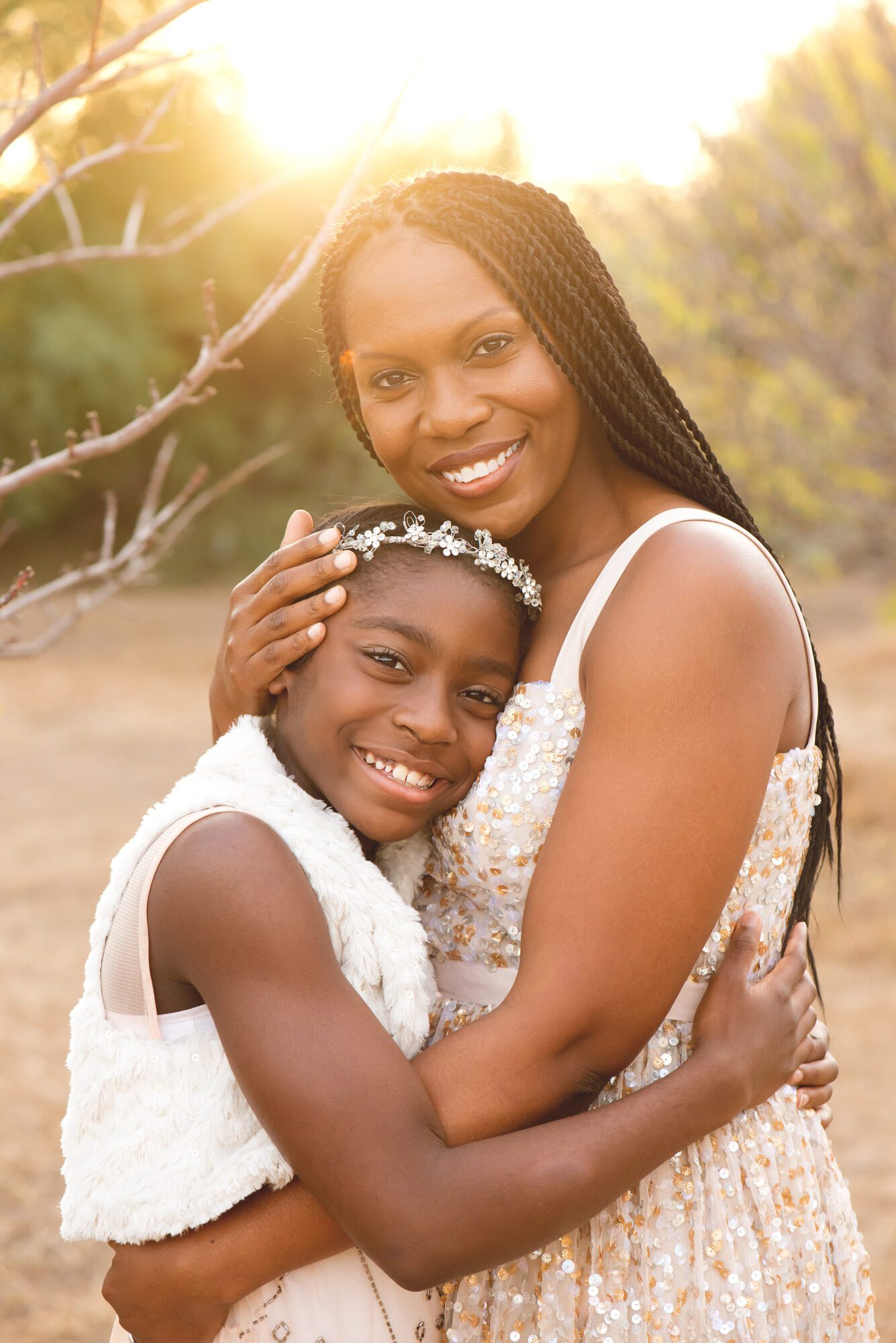 Young girl with mother embracing in golden sunlight Chandler Luxury Photography Studio Family Portraits | Reaj Roberts Photography