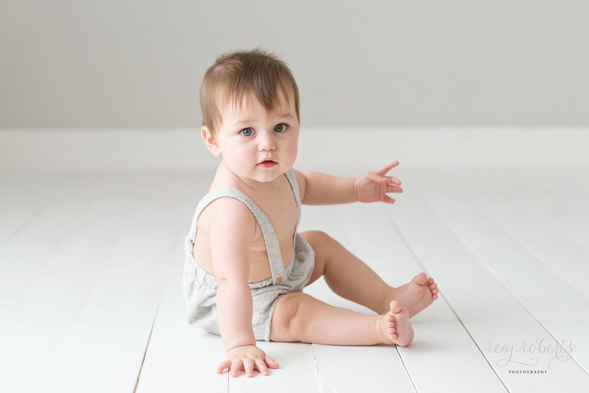 Chandler baby photographer | Reaj Roberts Photography | baby boy sitting up in suspenders outfit