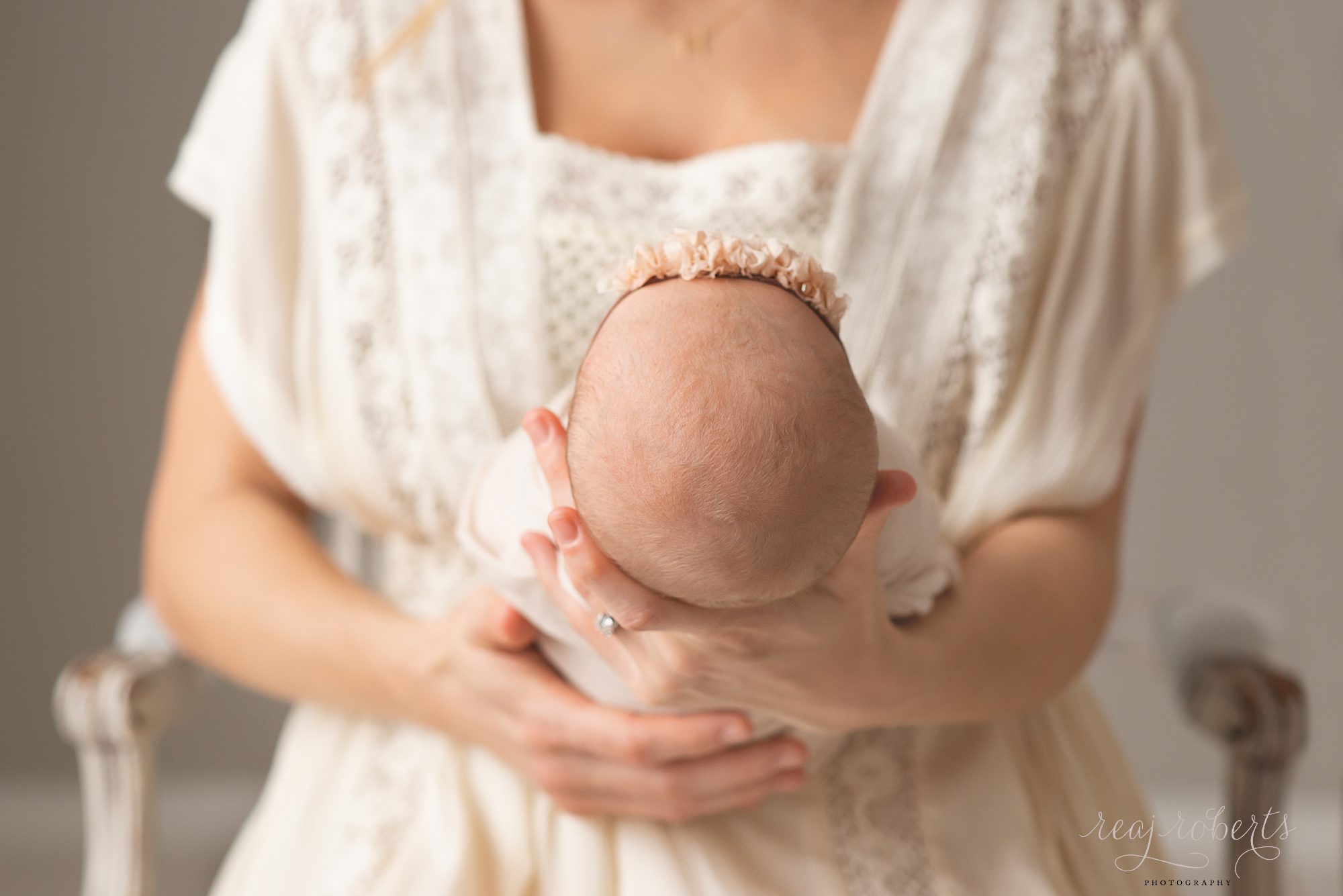 newborn baby girl held by mother | Reaj Roberts Photography