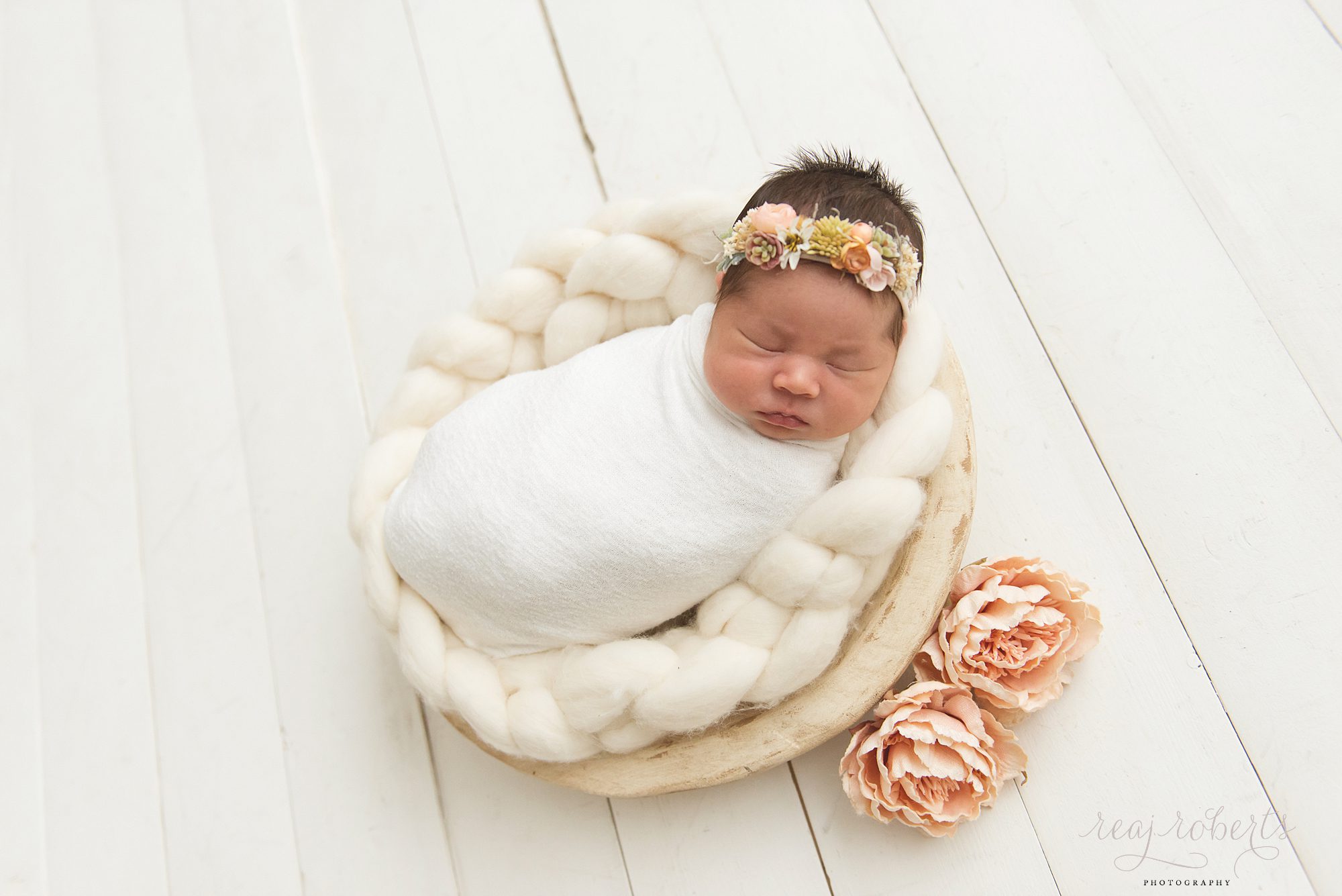 Chandler Baby Photographer | Reaj Roberts Photography | newborn girl with blush pink flowers inside a cream bowl on white wood floors farmhouse style succulent headband