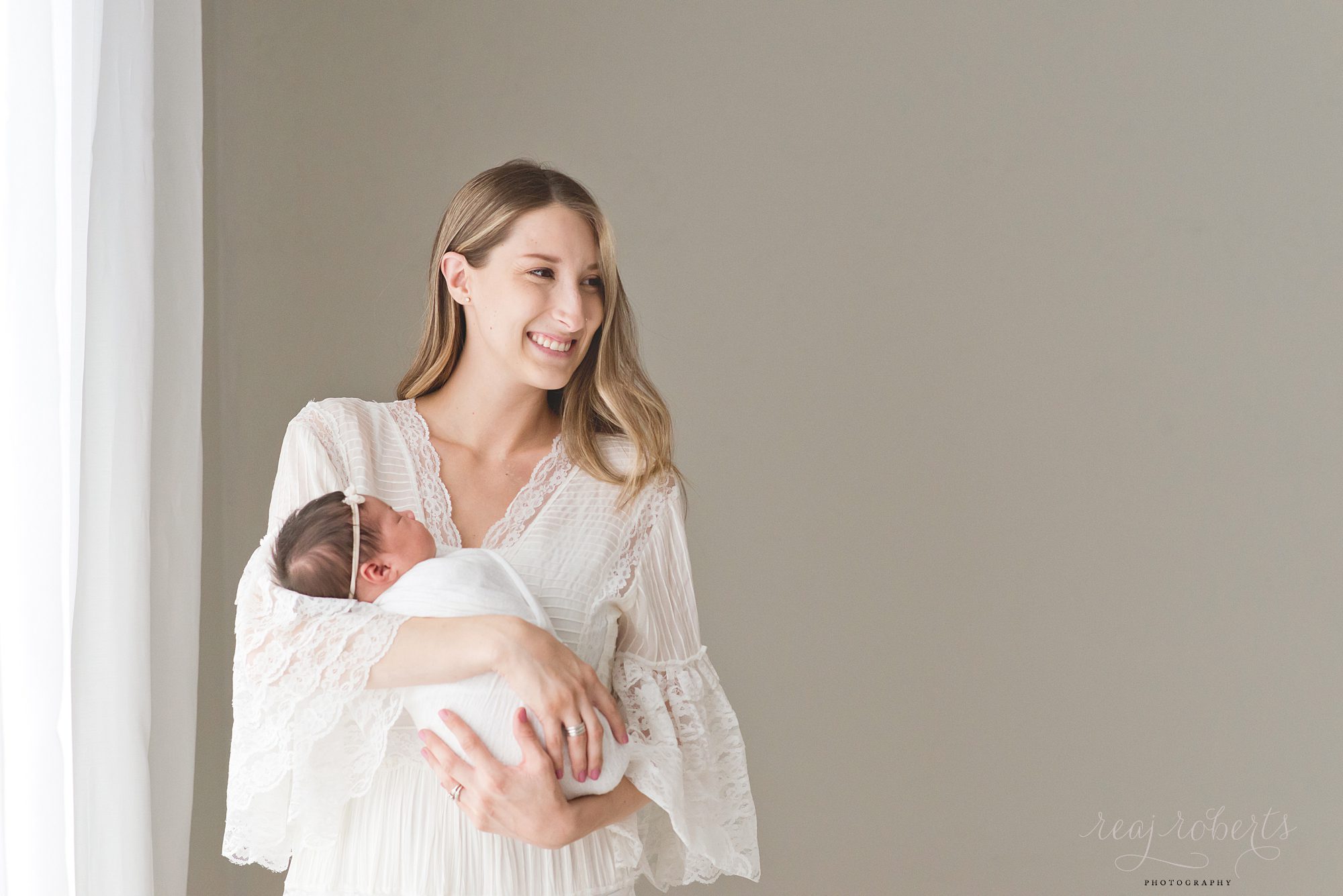 Phoenix Baby Photographer | Reaj Roberts Photography | proud happy mother smiling holding newborn