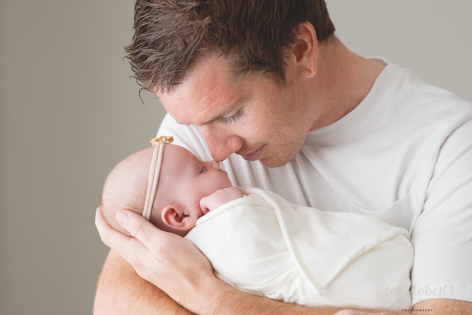Newborn baby girl with father | Reaj Roberts Photography