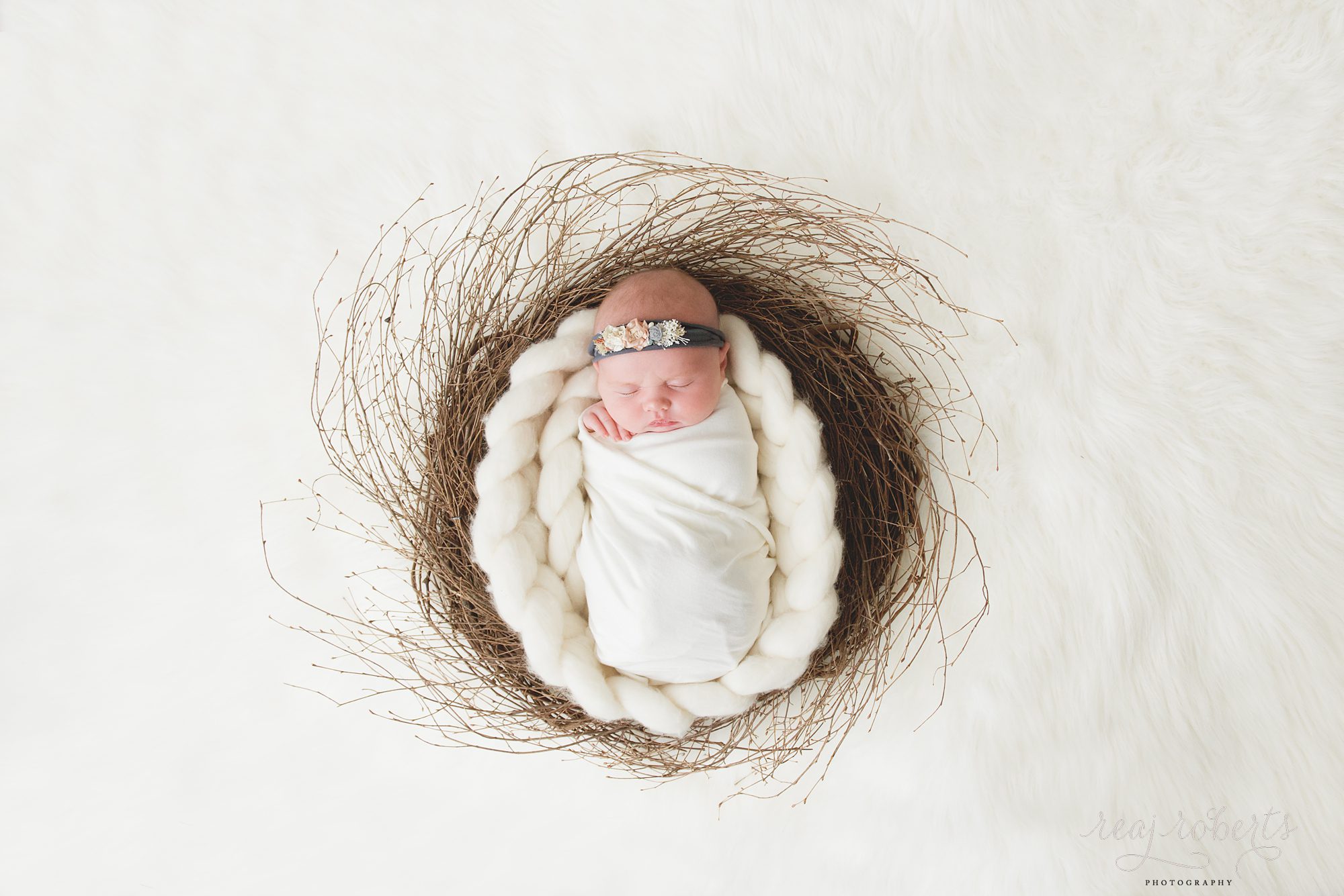 Newborn wrapped in basket | Reaj Roberts Photography