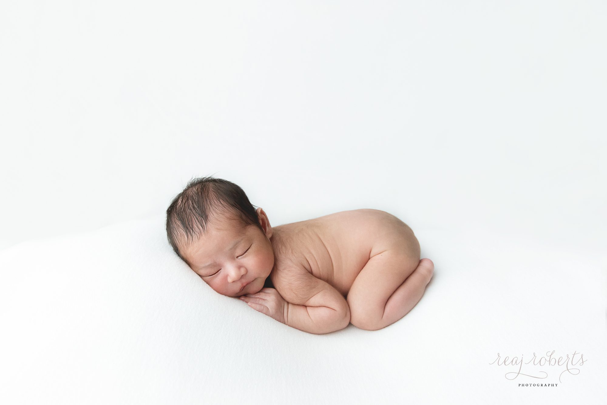 simple clean modern timeless newborn photos of baby on tummy | Reaj Roberts Photography
