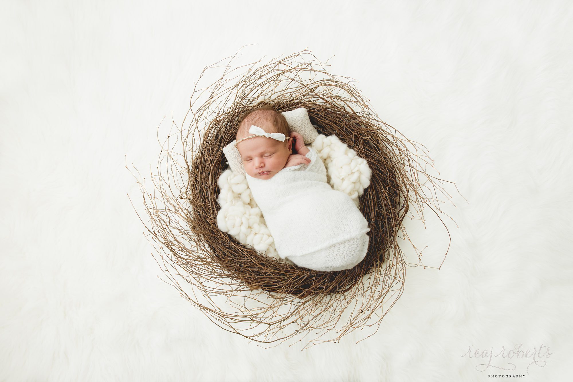 newborn baby girl in wreath | Reaj Roberts Photography