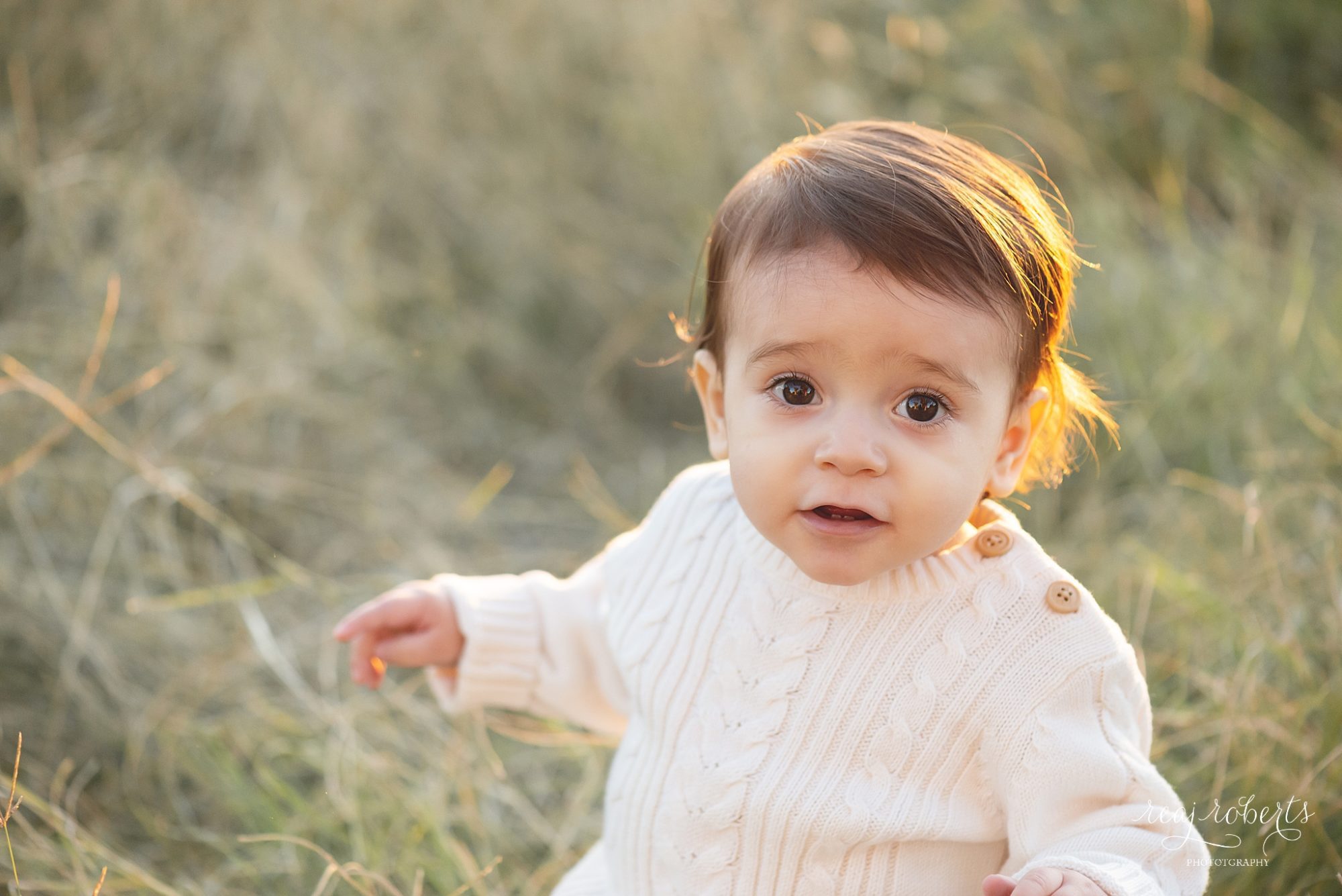 Baby boy in cream cable knit romper in tall grass field at sunset | Phoenix Family Photographer | Chandler Family Photographer | Reaj Roberts Photography