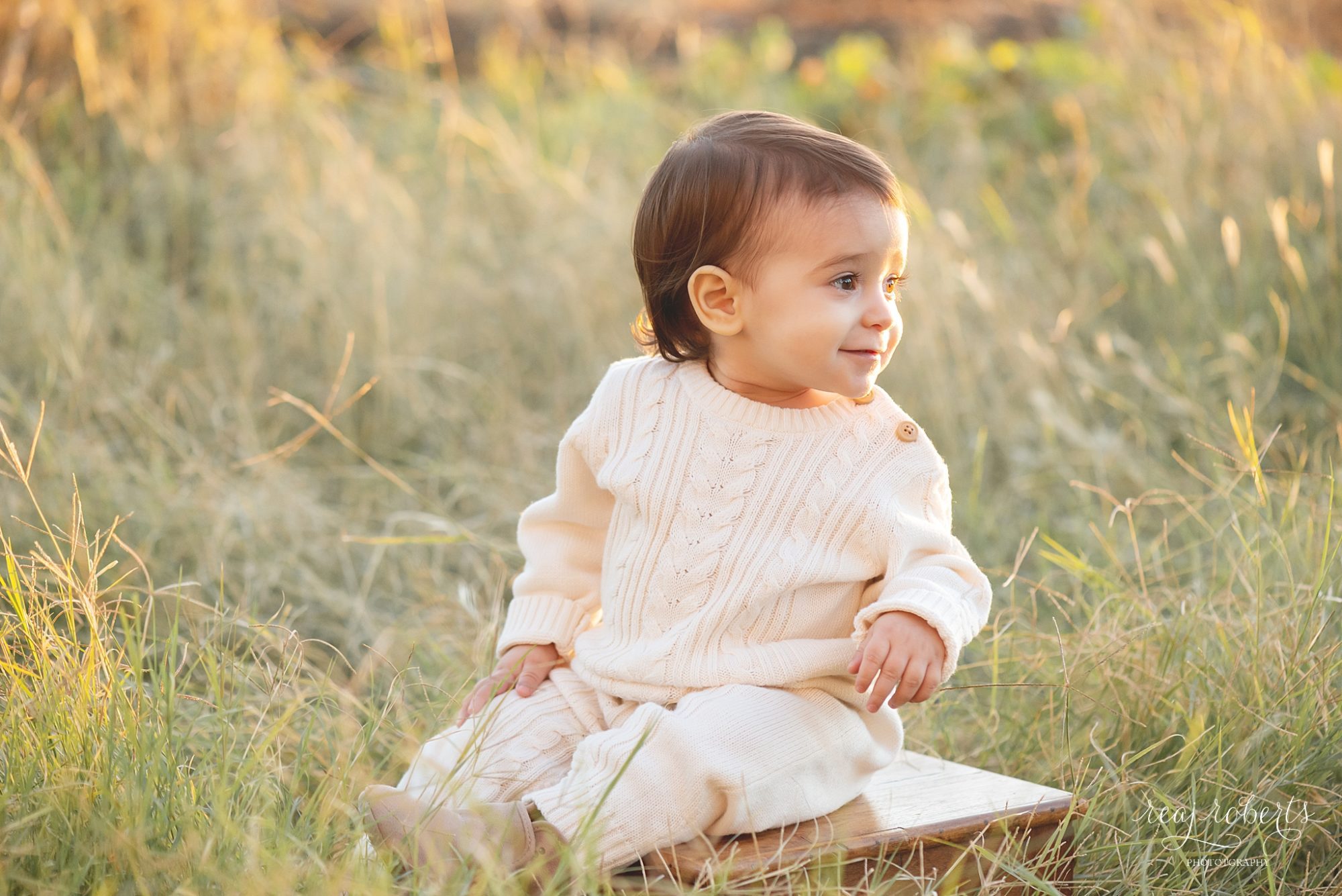 Cream cable knit romper gender neutral baby clothing, baby boy smiling in tall grass field | Chandler Family Photographer | Reaj Roberts Photography