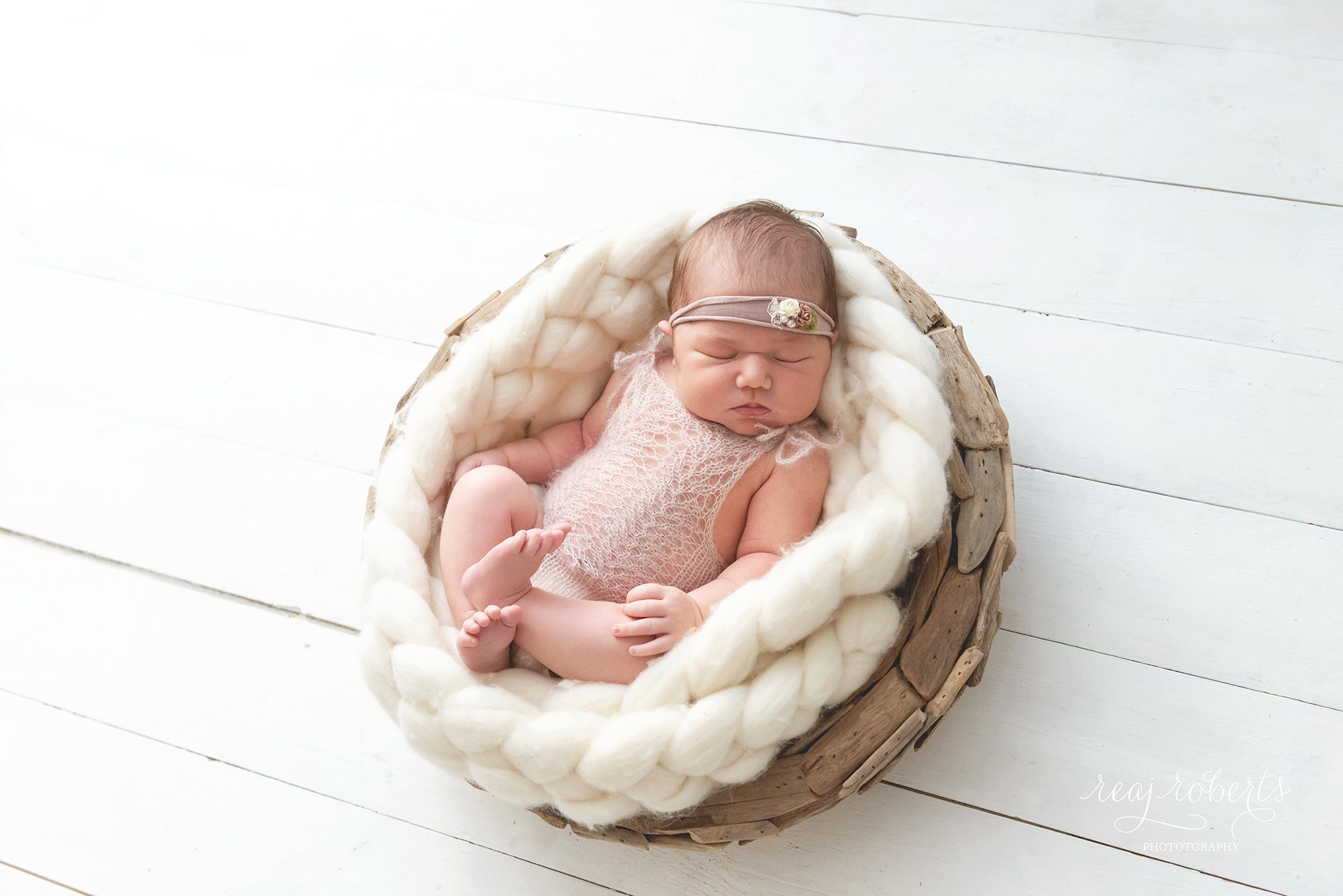 baby girl mohair knit lace romper cream wool braid in driftwood bowl white wood floor studio newborn photography | Reaj Roberts Photography