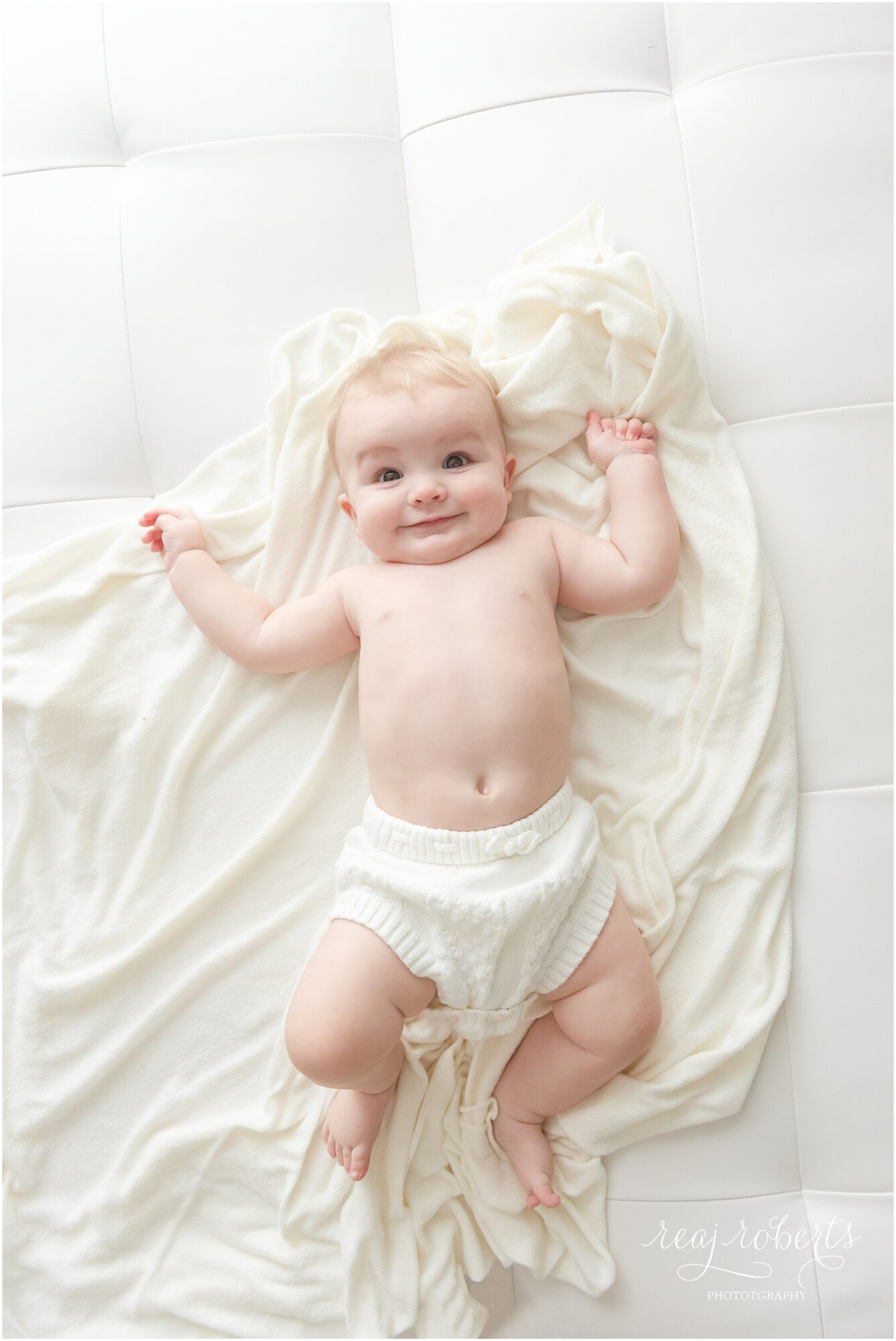 6 month baby session simple clean baby boy smiling in white