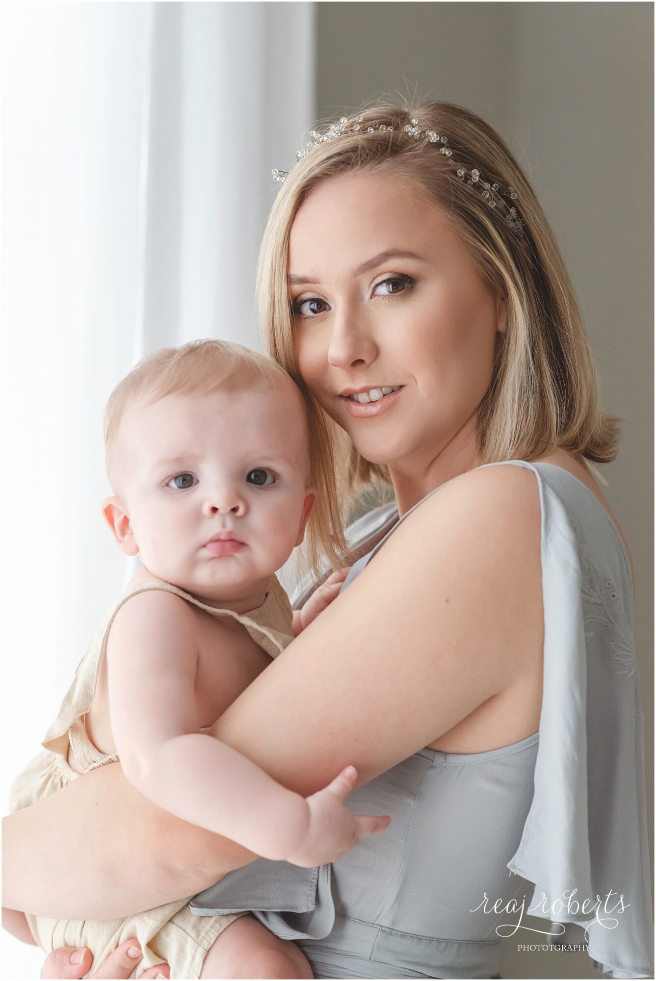 6 month baby boy held by mom by Reaj Roberts Photography