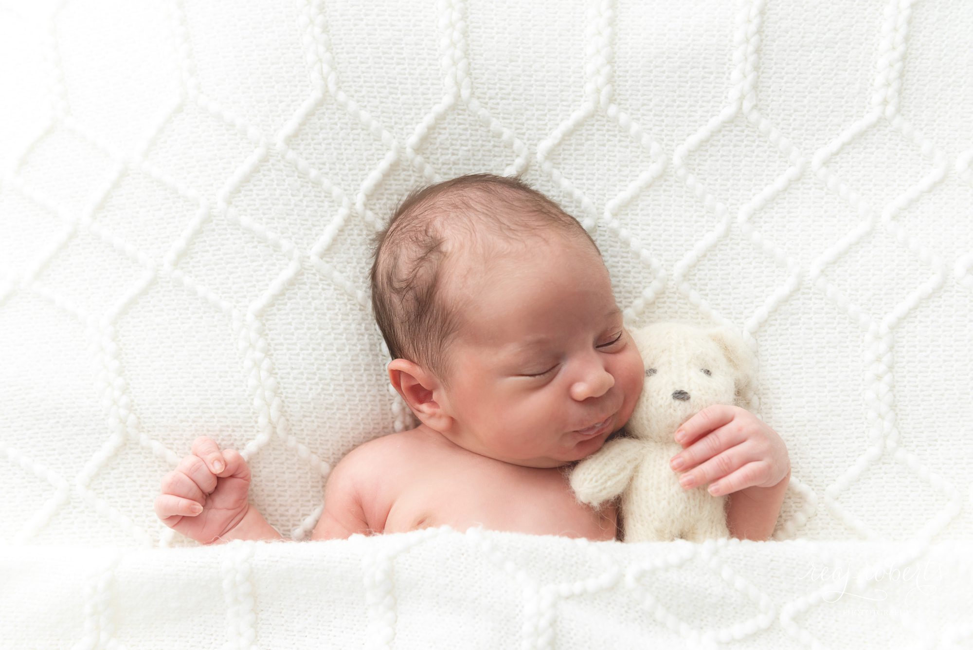 Phoenix newborn photographer baby boy tucked in with small bear | Reaj Roberts Photography