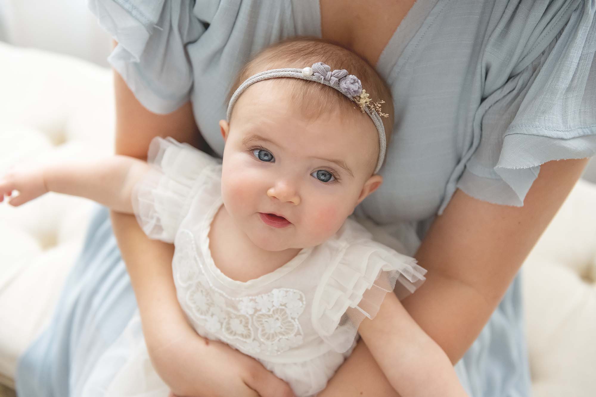 baby girl sitting in mother's lap | Reaj Roberts Photography