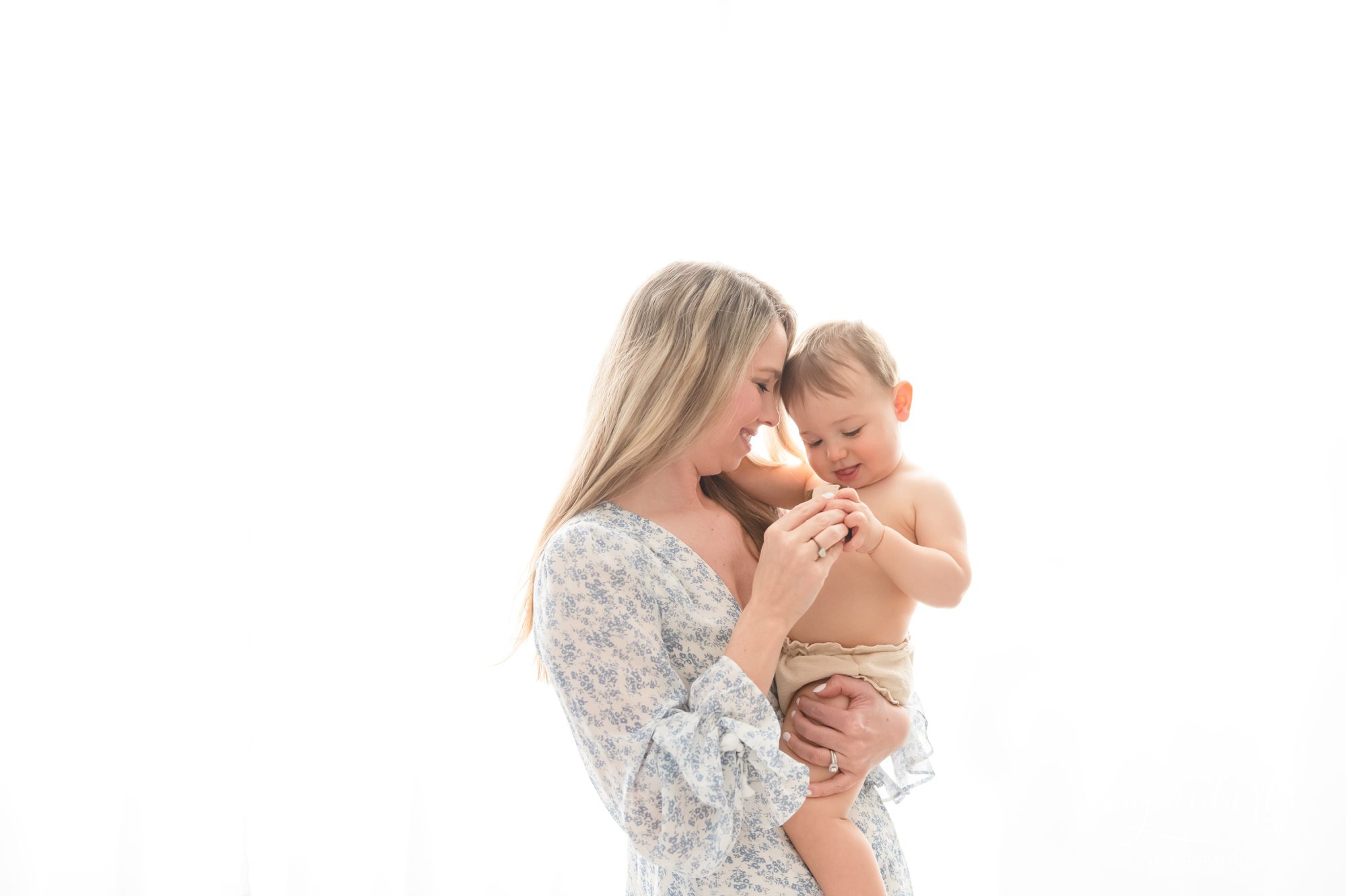 Mother holding baby boy in front of window | Phoenix Motherhood Photographer | Reaj Roberts Photography