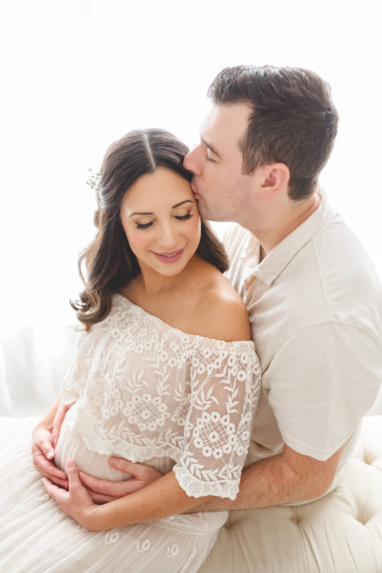 Scottsdale luxury pregnancy photographer mother and father sitting by Reaj Roberts Photography