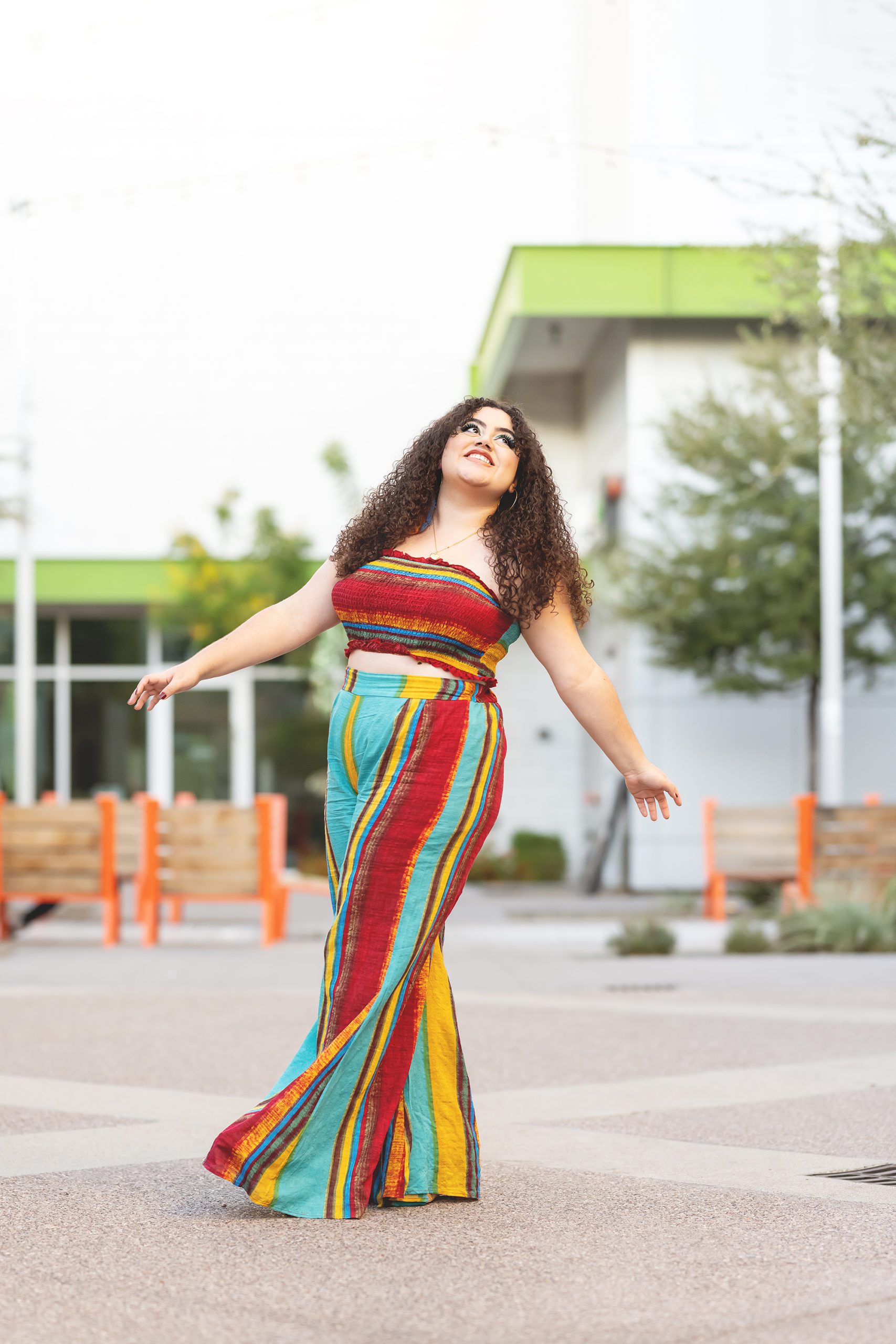Chandler senior photographer girl kicking her legs in colorful outfit © Reaj Roberts Photography